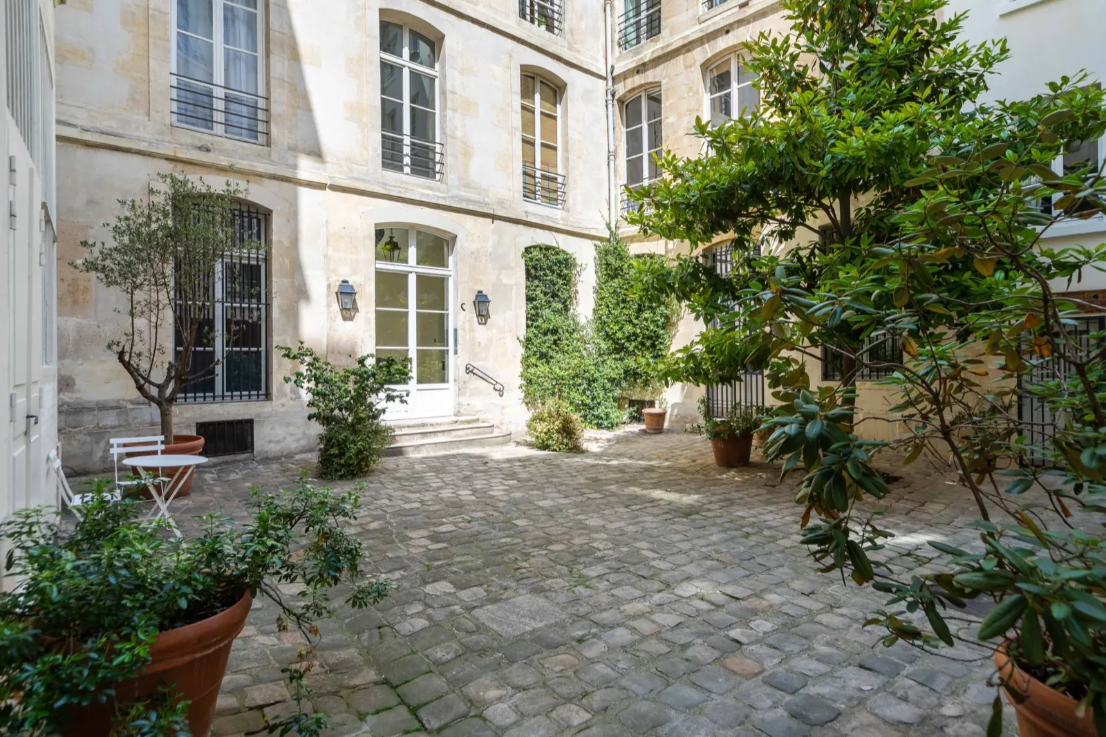 Façade d'un immeuble haussmannien parisien vue en contre-plongée avec balcons en fer forgé
