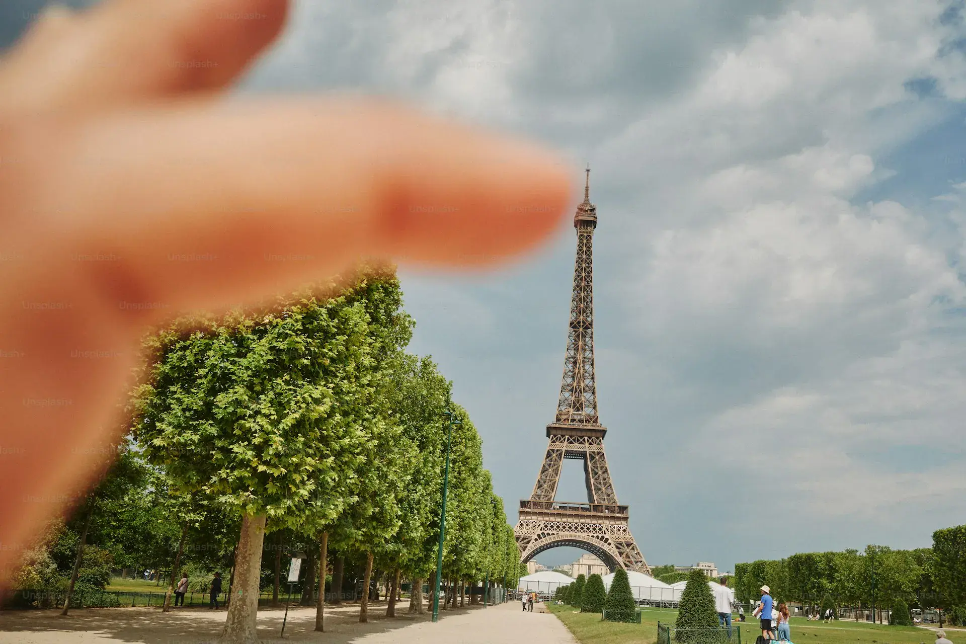 Handshake between a buyer and an estate agent in front of a Parisian building