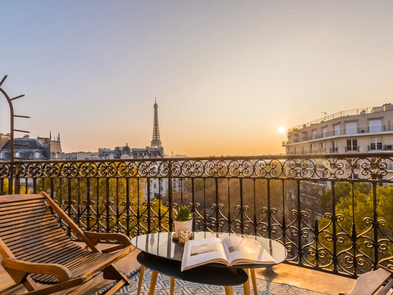 Fauteuils sur un balcon parisien face à la tour Eiffel