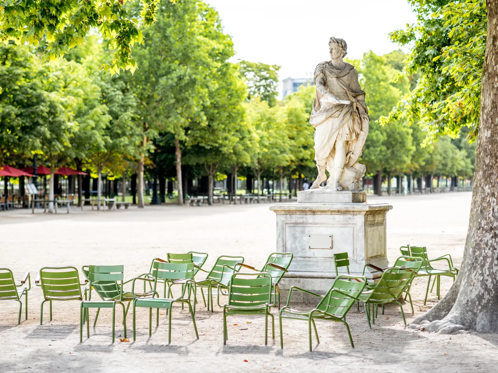 Green chairs and a statue in the Palais-Royal garden