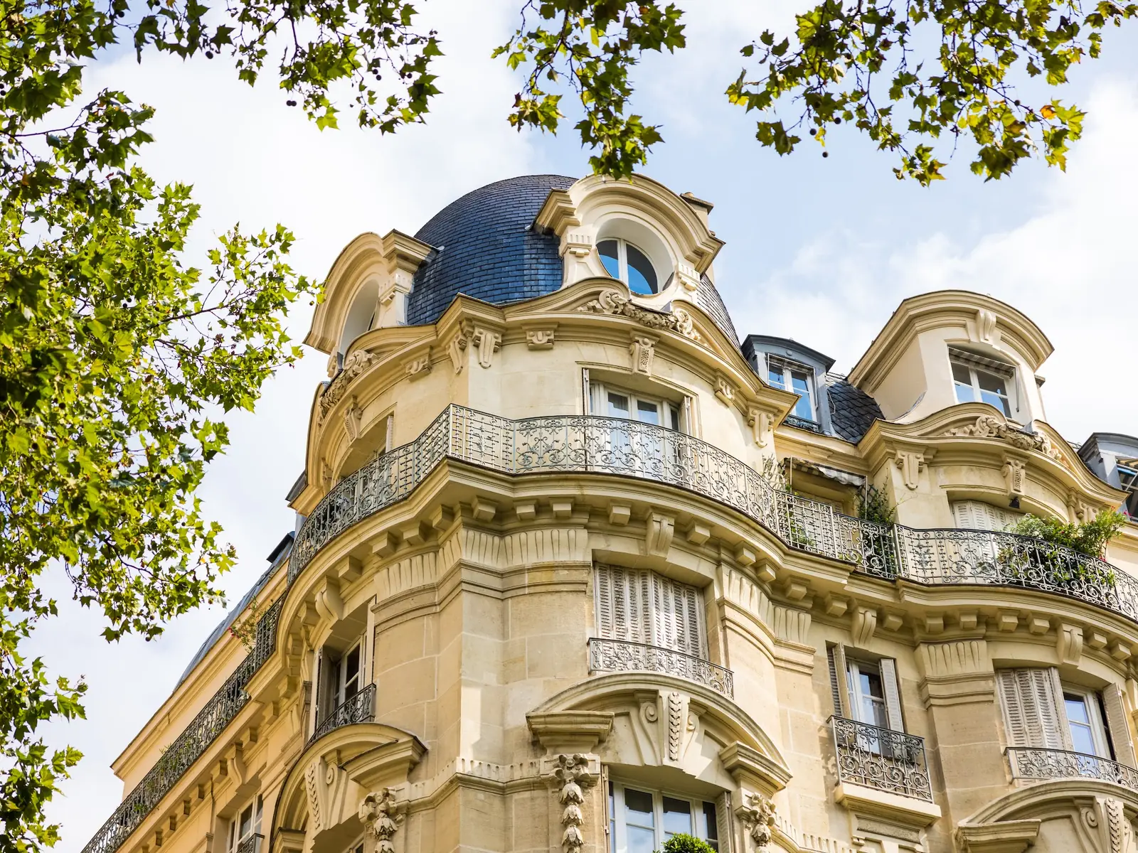 Haussmann building shot from below against a blue sky