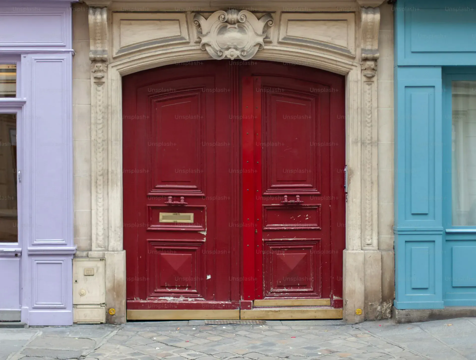 Couple in front of two Parisian apartment doors symbolizing the choice between selling and buying