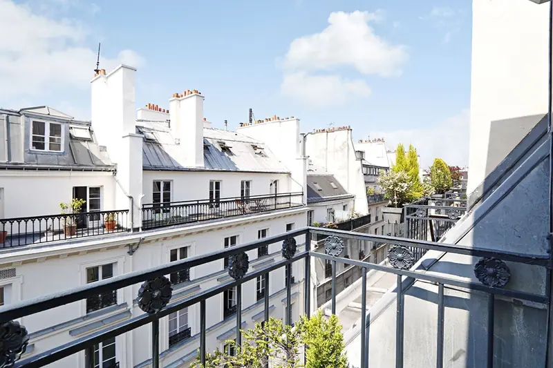 View over the Paris rooftops from the balcony of a Haussmann apartment