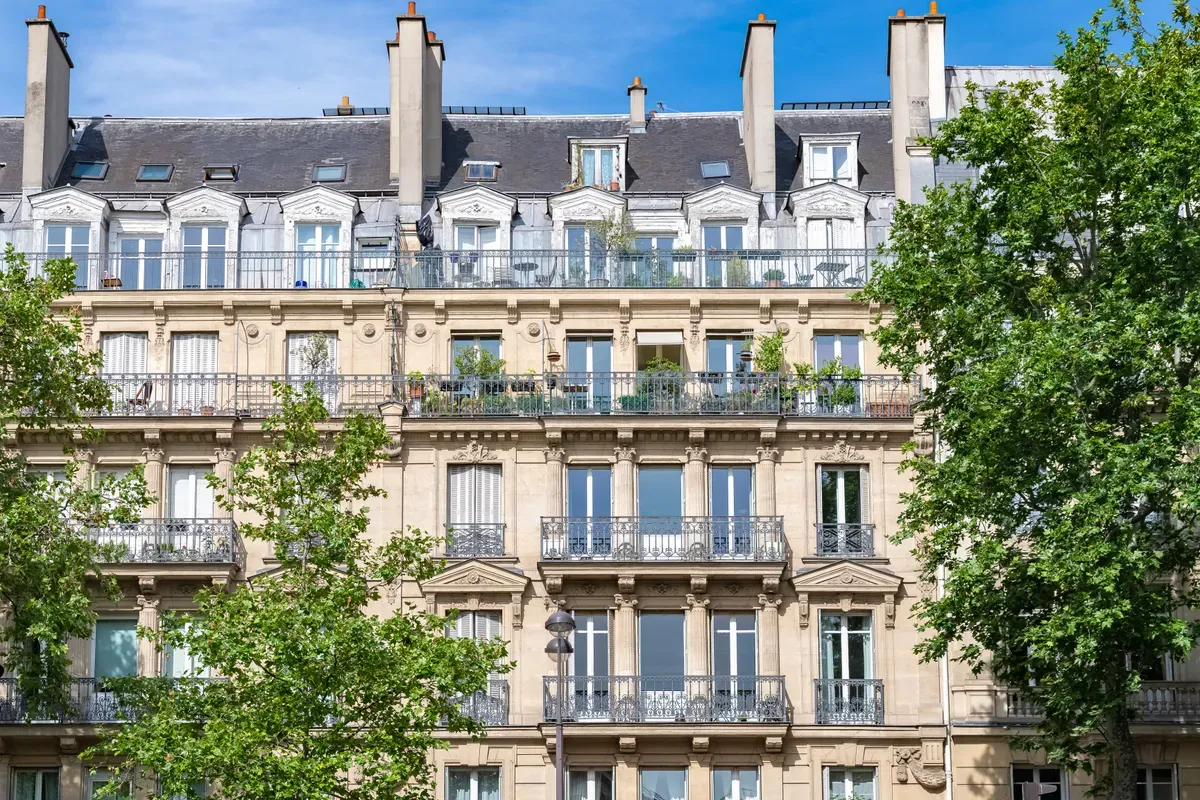 Facade of a Haussmann building with wrought iron balconies in Paris
